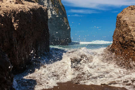 Blue Water Waves Crashing on Black Rocks at Santa Barbara Beach, San Miguel Island, Azores, Portugalの写真素材
