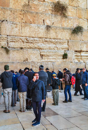 JERUSALEM, ISRAEL - DECEMBER 26, 2016: Jewish hasidic pray a the Western Wall, Wailing Wall the Place of Weeping is an ancient limestone wall in the Old City of Jerusalem.のeditorial素材