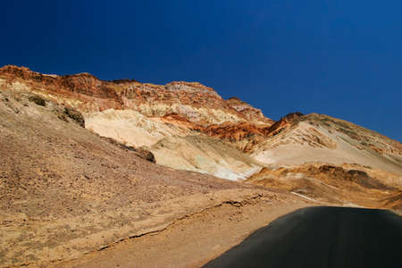 Lifeless landscape with road. Death Valley. California. USA