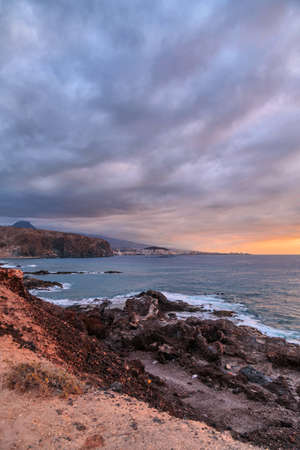 Volcanic stones beach in sunset time in Tenerife, Canary Islands, Spainの写真素材