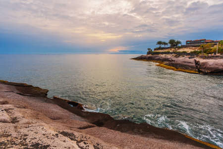 Rocks at topical beach at beautiful sunset. Costa Adeje, Tenerife, Spainの写真素材