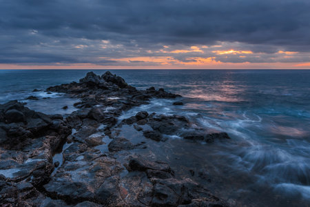 Volcanic stones beach in sunset time in Tenerife, Canary Islands, Spainの写真素材