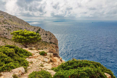 Landscape of rocky coast before a storm under gloomy dramatic sky (cape formentor). Mallorca. Balearic islands. Spainの写真素材