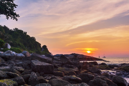 Beautiful sunset on the rock beach. Phuket, Thailandの写真素材