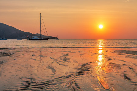 Parking Yachts near the beach at sunset time. Nai Yang beach. Phuket. Thailandの写真素材