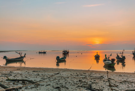 Traditional Thai boats near the beach at sunset time. Nai Yang beach. Phuket. Thailandの写真素材
