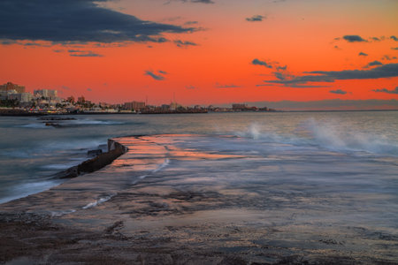 Stones pier at local beach at beautiful sunset. Costa Adeje, Tenerife, Spainの写真素材
