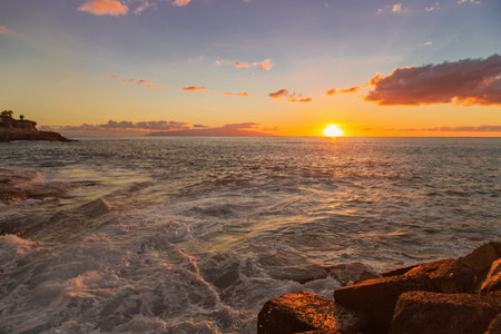 Rocks at topical beach at beautiful sunset.Costa Adeje, Tenerife, Spainの写真素材
