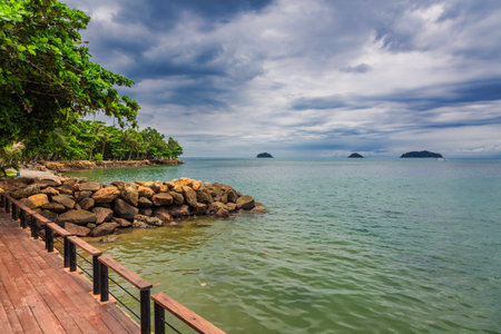 Wooden boardwalk at one of the hotels under a glowy dramatic sky on Kai Bae beach. Koh Chang island, Thailandの写真素材