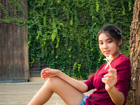 Asian woman sitting on the wood plateの写真素材