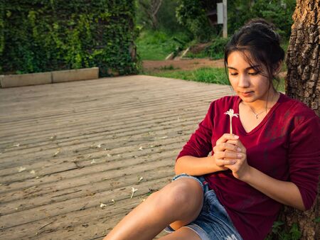 Asian woman sitting on the wood plateの写真素材