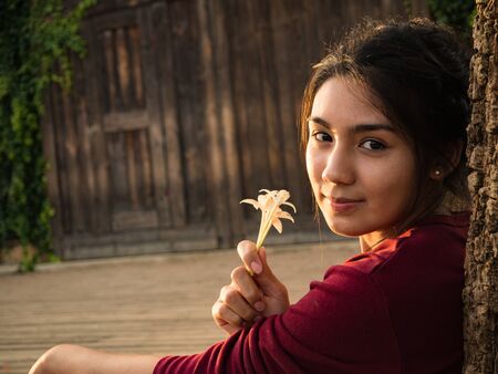 Asian woman sitting on the wood plateの写真素材