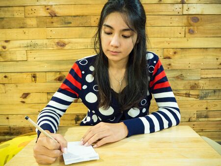 Asian woman writing on the paperの写真素材