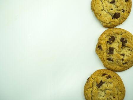 Chocolate chip cookies on white background, top view, copy spaceの写真素材