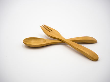 Wooden spoon and fork on white background