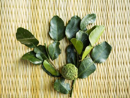 Bergamot and leaf on the brown matの写真素材
