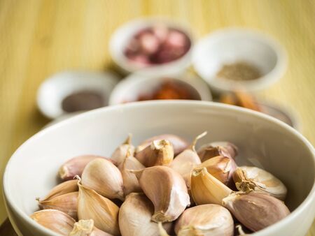 Closeup Garlic in the white cup, curry raw material backgroudの写真素材