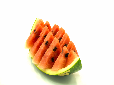 Slice of watermelon on the skin watermelon, isolated white backgroundの写真素材