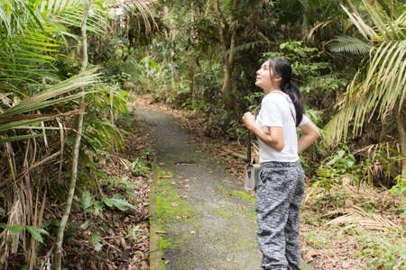 Beautiful young woman is traveling and camping in the forest