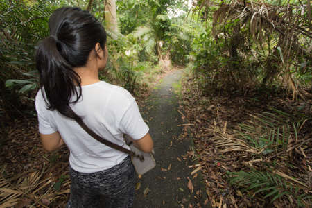 Beautiful young woman is traveling and camping in the forestの写真素材