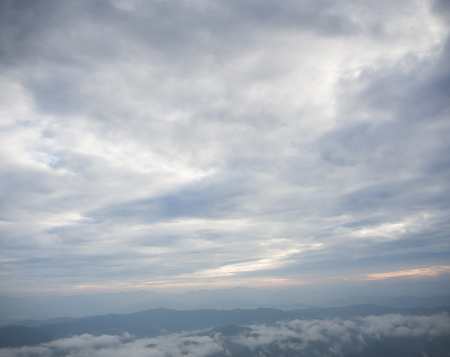 Beautiful cloudy weather over mountains, cloudy and fog in the moring with sunriseの写真素材