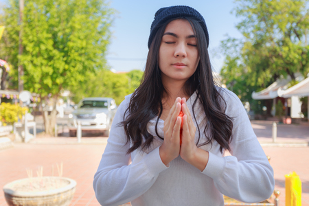 Asian woman pay homage to a Buddha image.の写真素材