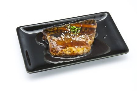 Japanese food style , Saba fish grilled with sauce in the plate on white backgroundの写真素材