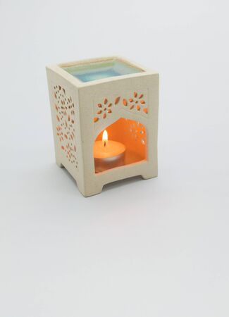 Aromatherapy lamp with burning candles isolated on white の写真素材