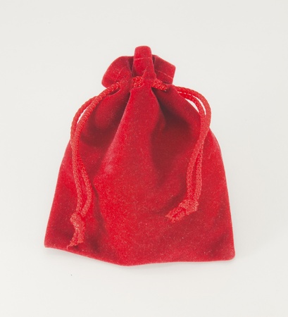 A little red bag with chain inside isolated over white の写真素材