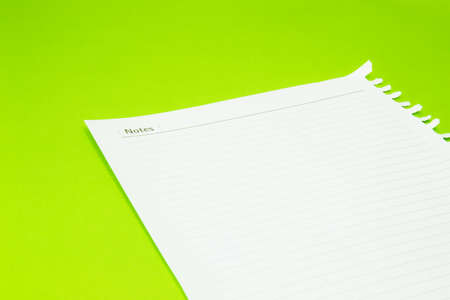 notebook paper on green background の写真素材