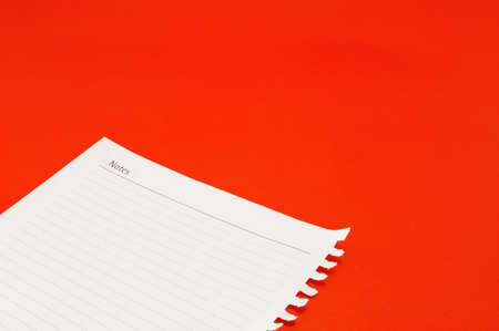 notebook paper on red background の写真素材