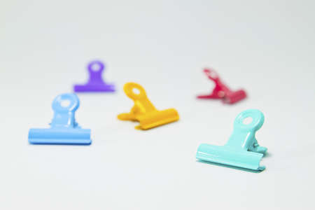 An image of colorful paper clips on white の写真素材
