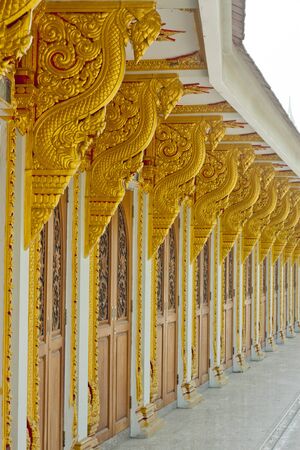 Ancient Golden carving wooden door of Thai temple の写真素材