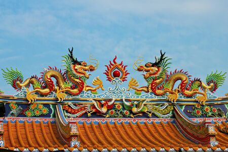 dragon on chinese temple roof with white background の写真素材