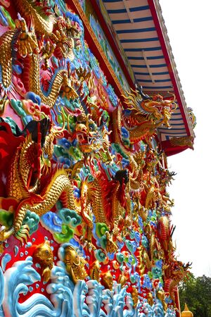 The golden dragon on the wall の写真素材