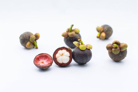 Mangosteen fruits with cut isolated on white backgroundの写真素材