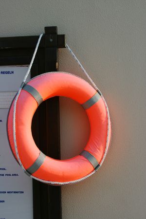 Lifebuoy ring hanging on a wall near to pool