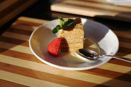 Slice of a pie and strawberry on a plate