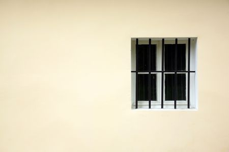 Small window with a protective iron latticeの写真素材