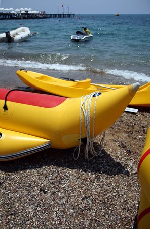 yellow inflatable boats for entertainment, ashore seaの写真素材