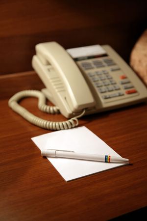 Desk in hotel with a paper and a penの写真素材