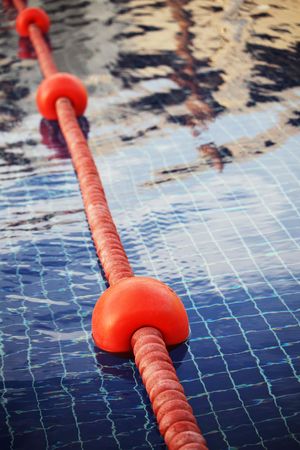 Rope with plastic anchor buoys in a swimming pool