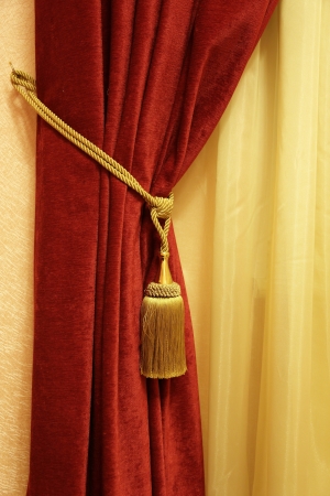 red curtain with a tassel and a ropeの写真素材