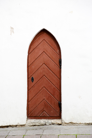 Old door red, in the wall of the houseの写真素材