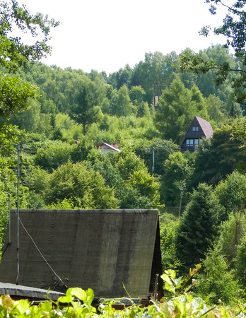 Traditional country houses and hills in Krzeszna, Kashubian Region, Poland. Travel and exploration concept.の写真素材