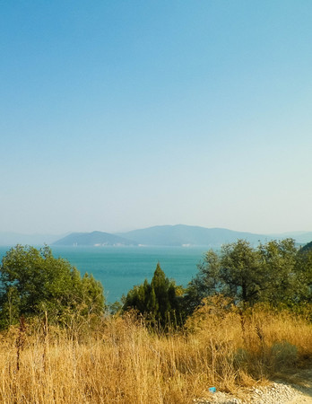 View on coast of Lake Prespa and Mountains of Galicica National Park, Macedonia. Galicica is National park between two lakes - Ochrid and Prespa, known of it's wild nature. Balkan nature and exploration concept.の写真素材