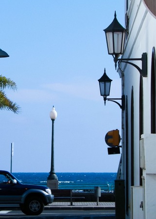 Street view of street in Arrecife and ocean in a background. Arrecife is biggest and capital city in Lanzarote, Canarian is. Travel and architecture concept.の写真素材