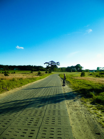 Offroad in Kashubian village. Kashubia is part of northern Poland, known of it's beautiful nature. Lonely person traveling across village road, summer season, beautiful Polish environment.の写真素材