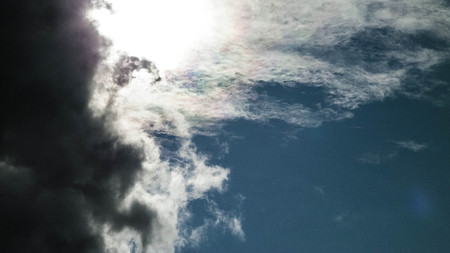 Sun hidden behind dark clouds. Weather forecast concept, copy space.の写真素材