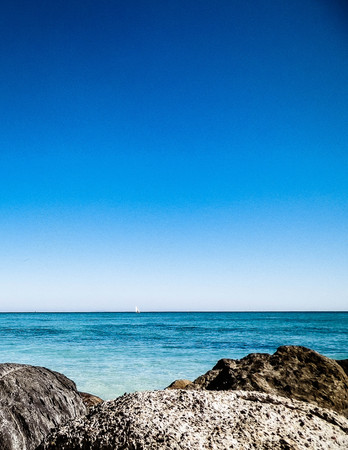 Stones on the beach in Vada, transparent, turquoise water and white sand. Travel and nature concept.の写真素材